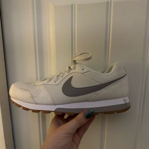 Nike sneakers. Off white/cream with grey. Tan brown on bottom - good contrast.